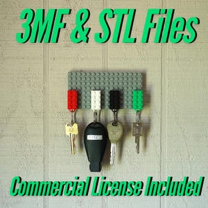 May include: A gray Lego brick key holder with five keys attached. The keys are attached to red, white, black, and green Lego bricks. The text "3MF & STL Files" is at the top of the image and the text "Commercial License Included" is at the bottom of the image.