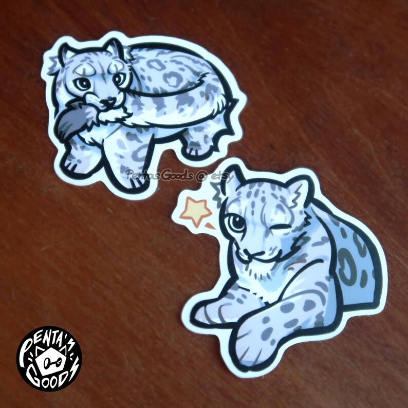 May include: Two stickers featuring cartoon snow leopards. One sticker shows a snow leopard curled up, holding a bird. The other sticker depicts a winking snow leopard with a star graphic. The stickers have a white border.