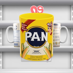 May include: A yellow mug with a white handle. The mug has a picture of a corn cob and the text "P.A.N. Since 1960" on it. The text "Harina de Maiz Blanco Precocida Contenido Neto 1kg" is also on the mug.
