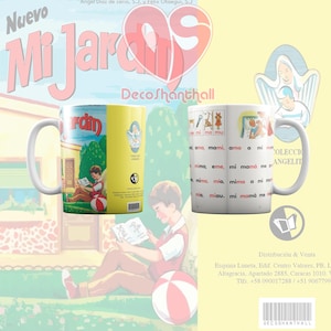 May include: A white ceramic mug with a yellow and red design. The mug features a cartoon image of a child reading a book in a garden. The text "Mi Jardin" is printed on the mug in a red and yellow font. The mug also features the text "Coleccion Angelitos" in a black font.
