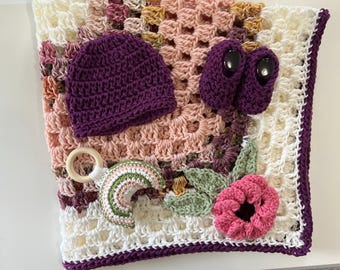 Crochet Baby Blanket Gift Set: Pink, white, and multicolored crib blanket with flower applique and handmade baby rattle toy