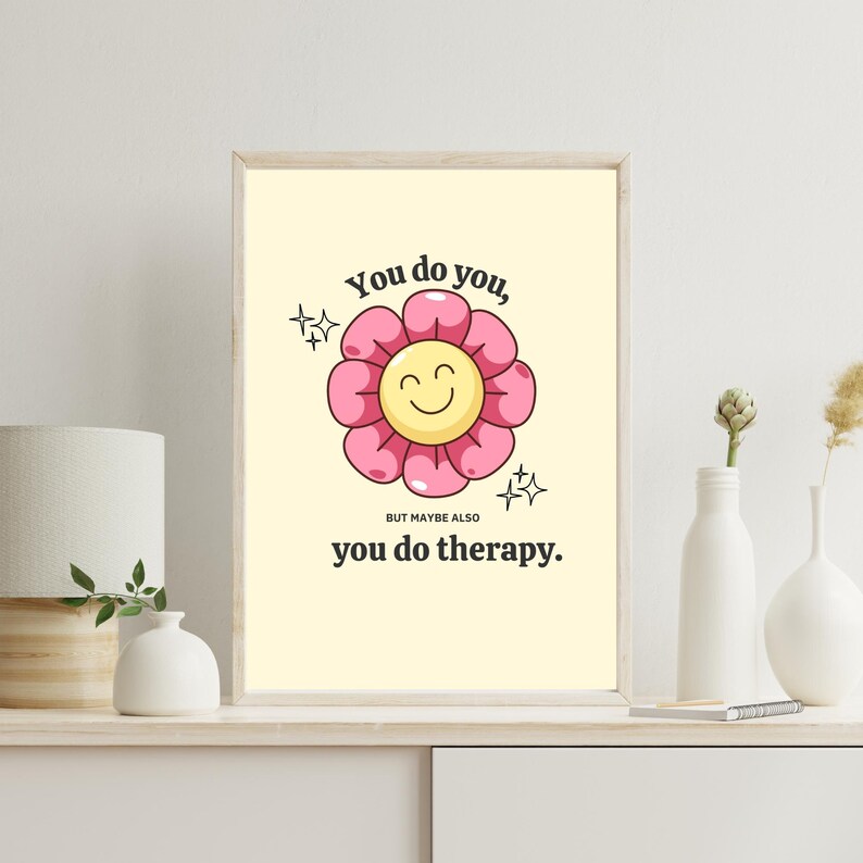 May include: A yellow and pink flower with a smiling face, surrounded by sparkles, with the text "You do you, but maybe also you do therapy."