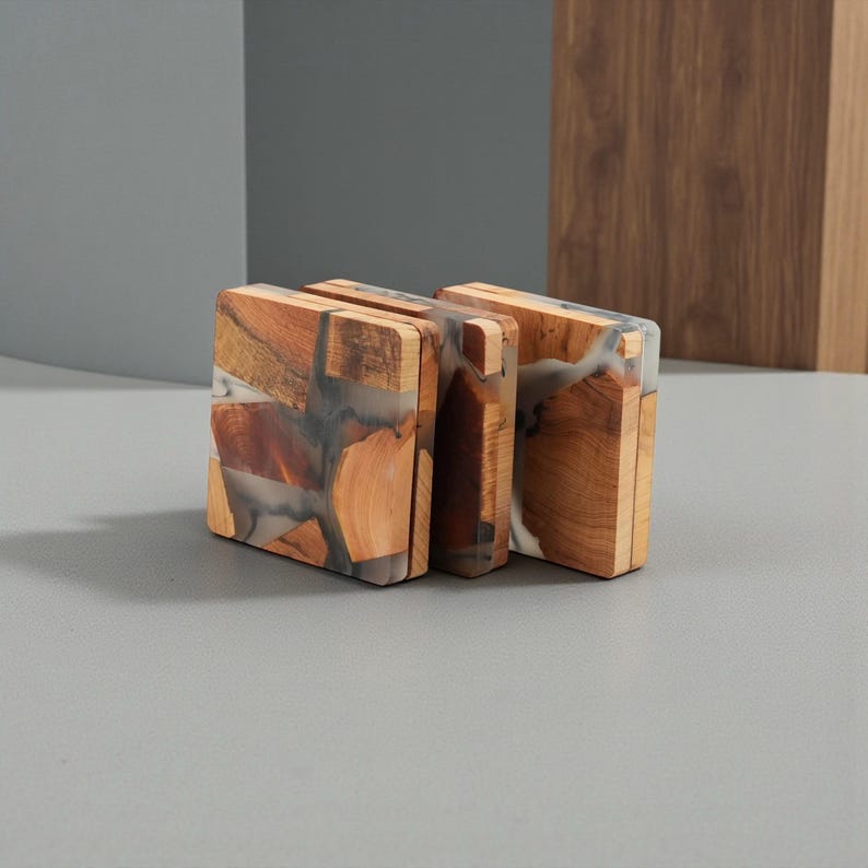 Six rectangular wooden coasters with a unique design. The coasters are made of wood and resin, with a mix of brown, gray, and white colors. The coasters are standing upright, showcasing their intricate details and craftsmanship.