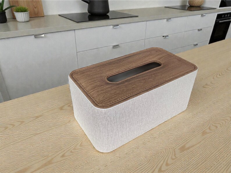Rectangular PU leather tissue box cover with linen‑style beige texture and stitched wooden top, designed to fit standard Kleenex rectangular boxes. Features a modern, minimalist look that blends seamlessly with home décor styles from contemporary to boho. Durable magnetic closure allows easy tissue replacement, while the elegant design makes it perfect for bathroom, bedroom, living room, or office use. A stylish and functional home accessory or thoughtful gift idea.