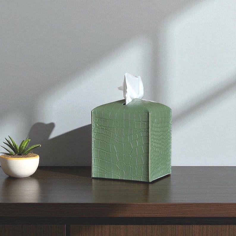 Contemporary napkin holder, tissue box organizer, tissue dispenser, tissue box protector, napkin organizer, bathroom decor accessories, leather storage box, square tissue box holder, woven design, facial tissue cover, crocodile leather tissue dispenser, square tissue box protector.