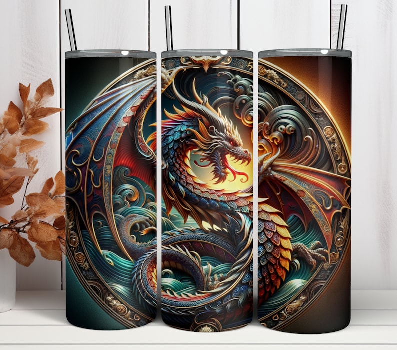 May include: A set of three stainless steel insulated tumblers with a detailed dragon design. The dragon is depicted in vibrant colors, including blue, red, and gold, set against a dark background. Each tumbler has a black straw and a lid.