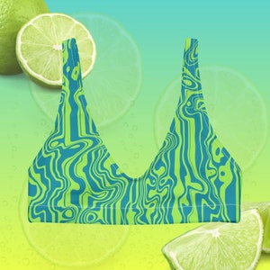 May include: A lime green and blue patterned bikini top. The top features a vibrant, abstract design with swirling lines of bright green and blue. The background includes lime slices and a gradient of green and blue.