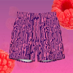 May include: Pink and purple patterned swim trunks. The shorts feature a wavy, abstract design in shades of pink and purple. The background is a gradient of pink and purple with a few raspberries.