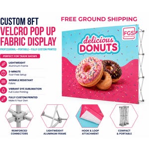 May include: A custom 8ft Velcro pop up fabric display featuring a graphic of three donuts on a pink and blue background with the text "delicious DONUTS". The display includes a lightweight aluminum frame, hook and loop attachments, and connectors.