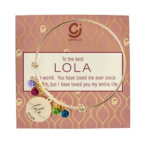 May include: Gold bangle bracelet with a charm that says "Lola Est. 2016". The bracelet comes with a card that says "To the best Lola in the world. You have loved me ever since I was born, but I have loved you my entire life."