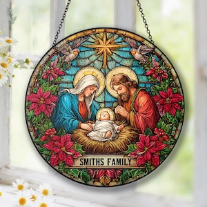May include: Round stained glass panel depicting the Nativity scene. The image features Mary, Joseph, and baby Jesus, surrounded by red poinsettias and doves. The text "SMITHS FAMILY" is displayed at the bottom.