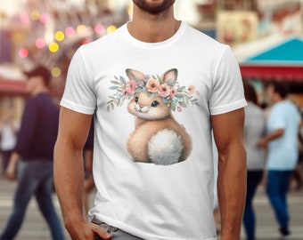 Puede incluir: Camiseta blanca con un lindo conejito de dibujos animados que lleva una corona de flores. El conejito es marrón y blanco con flores rosas en su corona.