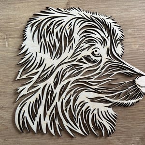 Könnte beinhalten: Ein Holzausschnitt eines Hundekopfes mit einem detaillierten, komplizierten Design. Das Fell des Hundes wird durch ein Muster aus Linien und Wirbeln dargestellt, was einen einzigartigen und künstlerischen Look erzeugt.