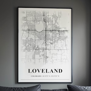 May include: A framed wall art print featuring a black and white street map of Loveland, Colorado. The design displays a detailed grid of roads and geographical features, with the text LOVELAND and COLORADO 40.3978 N, 105.0750 W printed below.