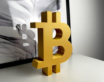 May include: A gold-colored, three-dimensional Bitcoin symbol.