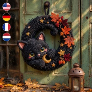 May include: A black crocheted wreath featuring a large black cat with yellow eyes holding a small golden crescent moon. The wreath is decorated with orange and red fabric maple leaves, small brown berries, and several small golden stars.