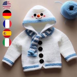 May include: White crocheted baby cardigan with a blue and white striped scarf and a snowman face on the hood. The cardigan has black buttons and blue trim.