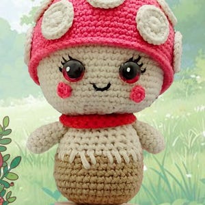 May include: A crocheted mushroom plush toy with a pink and white cap, white body, and brown stem. The toy has a smiling face with black eyes and red cheeks.