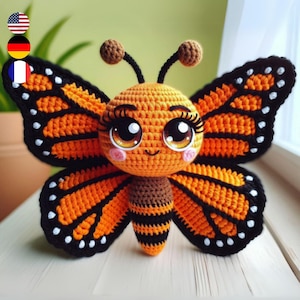 May include: A crocheted butterfly plush toy with orange and black wings, large brown eyes, and a brown and black striped body.