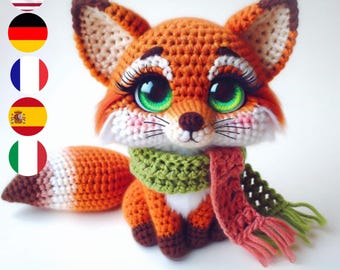 May include: A crocheted fox plush toy with a green and pink scarf. The fox has large, green eyes and a white muzzle.