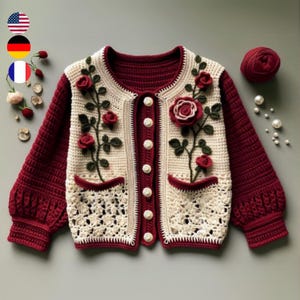 Può includere: Un cardigan all'uncinetto in crema e bordeaux. Il cardigan ha una chiusura con bottoni e presenta un motivo floreale con rose e foglie.