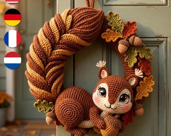 May include: A crocheted wreath featuring a large, textured brown squirrel with big eyes holding an acorn. The wreath is decorated with crocheted oak leaves in shades of green, orange, and brown, along with small crocheted acorns attached to the frame.