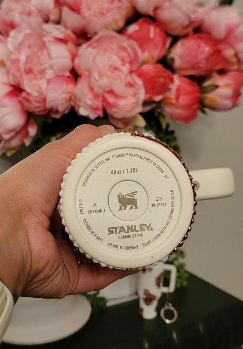 May include: A set of three ceramic mugs with a speckled, matte finish. The mugs are in shades of cream, light gray, and dark gray. Each mug has a simple, minimalist design, perfect for coffee or tea.