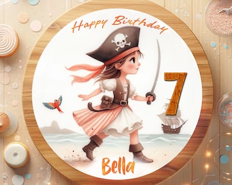 May include: A round wooden cake board with a white background. The board has a colorful illustration of a girl dressed as a pirate holding a sword. The girl is wearing a red bandana, a black pirate hat with a skull and crossbones, and a white shirt with a brown belt. The girl is standing on a beach with a ship in the background. The text "Happy Birthday" is written in orange at the top of the board. The number "7" is written in orange on the right side of the board. The name "Bella" is written in orange at the bottom of the board.