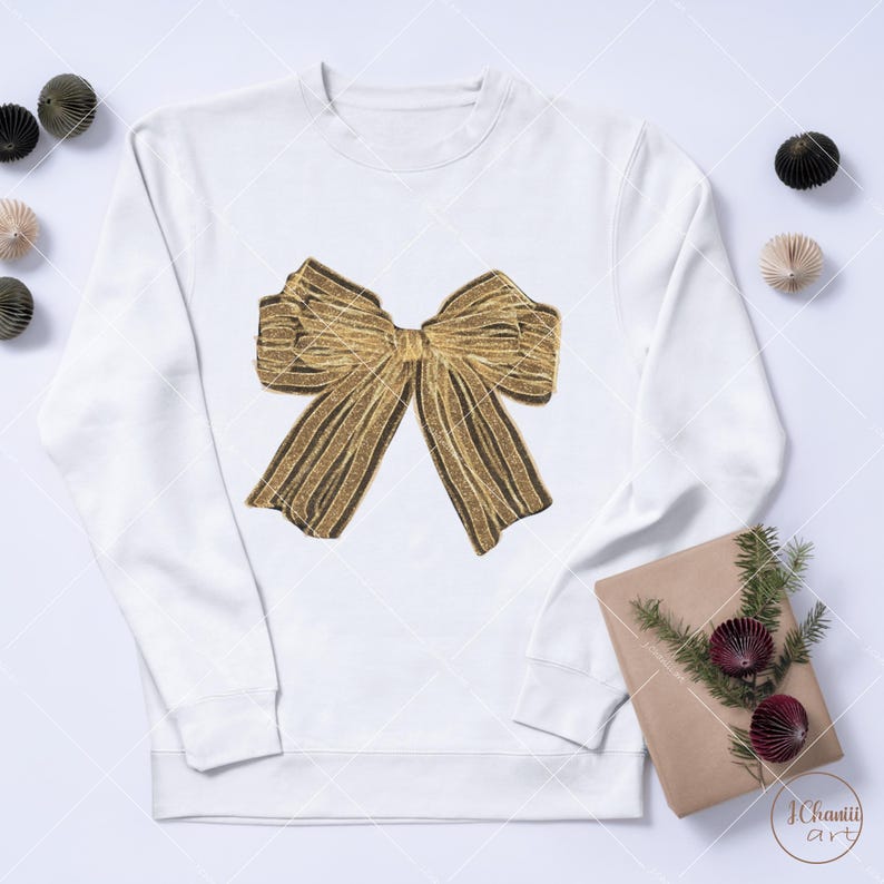 May include: A white sweatshirt featuring a gold glitter bow design.