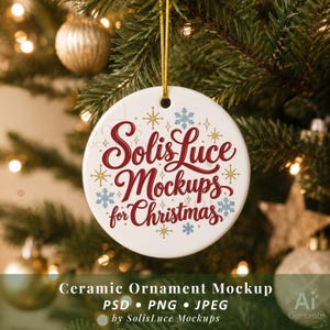 May include: A round white ceramic ornament featuring the red script text SolisLuce Mockups for Christmas, surrounded by small gold starbursts and light blue snowflakes, suspended by a thin gold string against a blurred evergreen tree background.