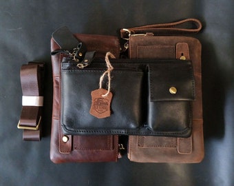May include: Two brown leather bags with a black leather bag attached. The black bag has a zippered pocket and the text "Old School" on a metal tag.