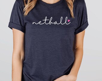 May include: A navy blue t-shirt with the word "netball" written in white cursive with a pink heart.