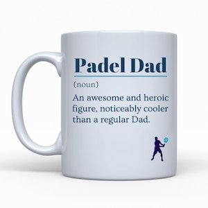 May include: White ceramic mug with the text "Padel Dad" in blue. The mug includes a definition of "Padel Dad" and a silhouette of a person playing padel. A great gift for a padel enthusiast.
