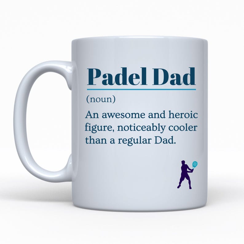 May include: White ceramic mug with the text "Padel Dad" in blue. The mug includes a definition of "Padel Dad" and a silhouette of a person playing padel. A great gift for a padel enthusiast.