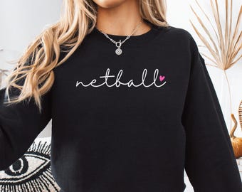 May include: Black sweatshirt with the word "netball" in white script and a small pink heart.