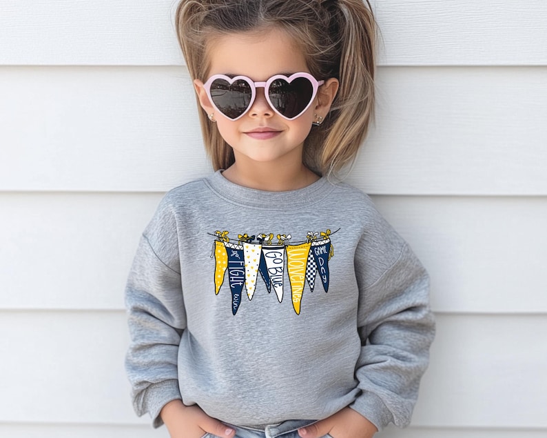 May include: A gray sweatshirt with a graphic of a string of pennants that say "Fight", "Go Blue", "Come On", and "Go Dawg".