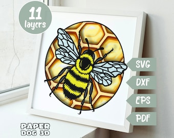 May include: A framed 3D paper art piece featuring a detailed bee design. The bee, with yellow and black stripes and blue-outlined wings, is set against a honeycomb background. The artwork includes the text "11 layers", "SVG", "DXF", "EPS", "PDF", and "PAPER DOG 3D".