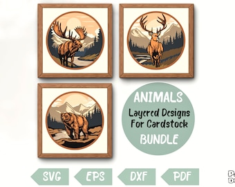 Puede incluir: Un conjunto de tres diseños de papel troquelado en capas que representan un alce, un ciervo y un oso en un entorno forestal. Los diseños están etiquetados como "ANIMALS Layered Designs For Cardstock BUNDLE".