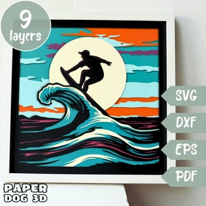 May include: A 9-layer papercraft design of a surfer riding a wave with a sunset background. The design is in shades of blue, orange, and white. The design is available in SVG, DXF, EPS, and PDF formats.