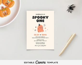 May include: A Halloween-themed invitation with the text "Isabelle is a Spooky One" and a cartoon ghost illustration. The invitation includes party details and a request to RSVP. A decorative spider and pumpkin cookies are also visible.