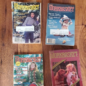 May include: Four vintage copies of The Workbasket magazine, a home arts magazine. The covers feature various knitting and crocheting projects, including a sweater and cap, a boudoir afghan, a hooded sweater jacket, and a Christmas stocking for a pet.