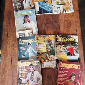 May include: A collection of vintage "The Workbasket" magazines featuring various craft projects, including knitting, crocheting, quilting, and sewing. The covers feature colorful illustrations and text, such as "Knit a Fashionable Spring Stole" and "Crochet this Romantic Wedding Gown".