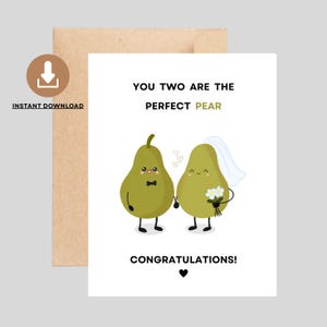 May include: A greeting card with a brown envelope. The card features two cartoon pears, one with a bow tie and the other with a veil, holding hands. Text reads "You Two Are The Perfect Pear Congratulations!" with a heart symbol.
