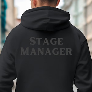 May include: Black hooded sweatshirt with the text "STAGE MANAGER" printed on the back.