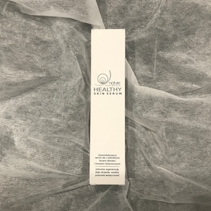 May include: White box with black text that reads "nature biostimulates HEALTHY SKIN SERUM". The box also includes a description of the serum in Polish.