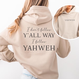 May include: A beige hoodie with the text "I don't follow Y'all way, I follow YAHWEH" printed on the back in black. The front of the hoodie has a pocket and the word "YAHWEH" printed on the hood.
