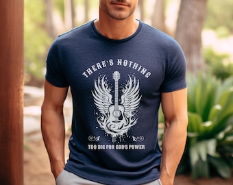 May include: A navy blue t-shirt with a white graphic of a guitar with wings and the text "There's Nothing Too Big For God's Power".
