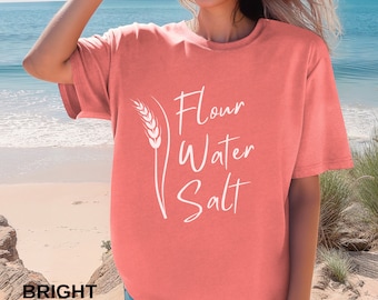 May include: A bright salmon colored t-shirt with a white graphic of a wheat stalk and the text "Flour Water Salt".