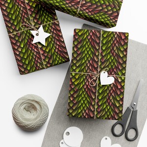 May include: Three gift boxes wrapped in green and red dragon scale patterned wrapping paper. The boxes are tied with twine and decorated with white paper stars and hearts.