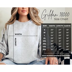 May include: Size chart for Gildan 18000 heavy blended crewneck sweatshirt. The chart shows measurements in inches for width, length, and sleeve length for sizes S through 5XL.